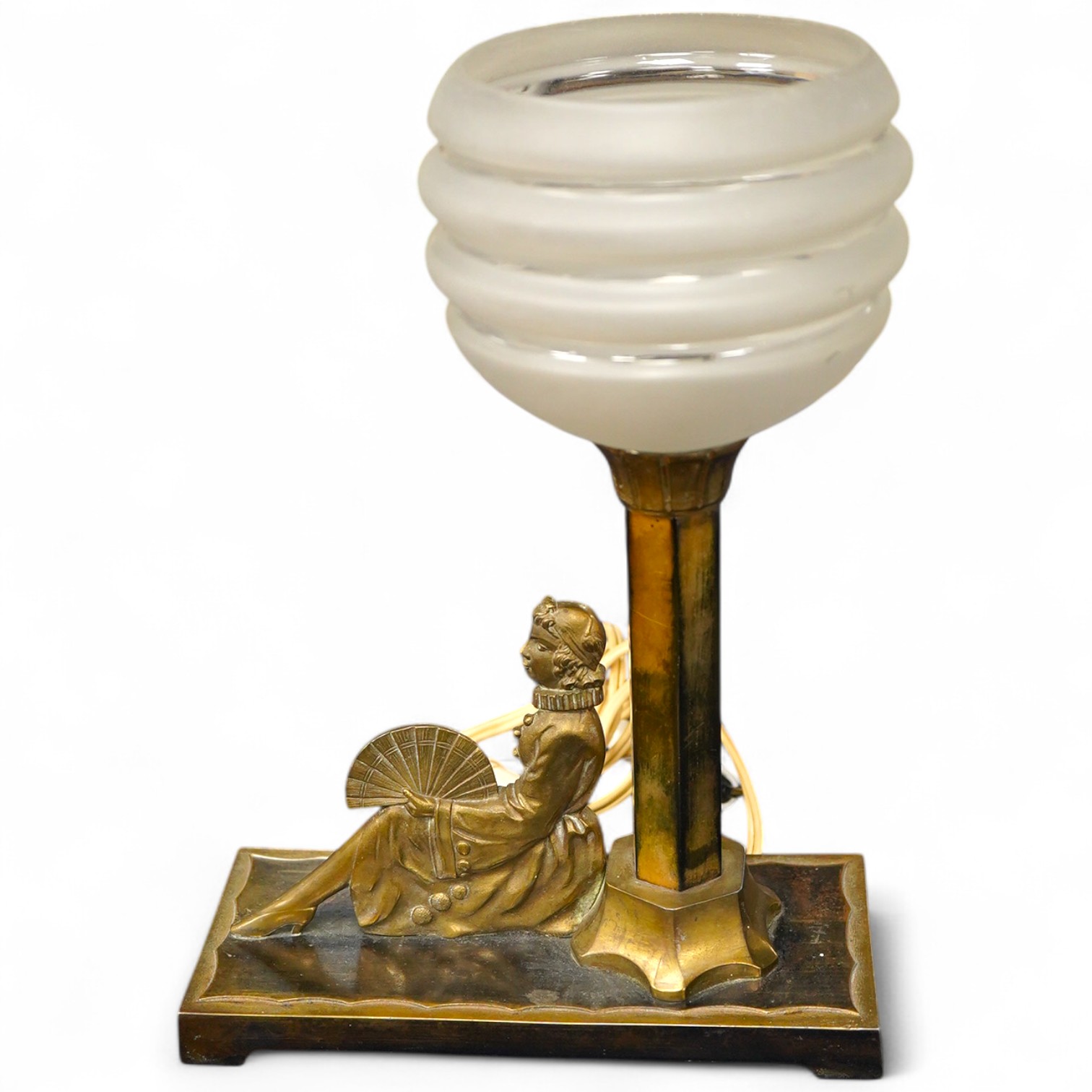 An Art Deco bronze table lamp, modelled with a seated woman holding a fan, 28cm high including shade